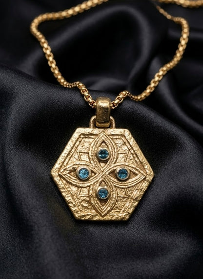 Tibeb Shield Pendant in solid 18k gold with blue sapphires, protection symbols cut in a hexagon