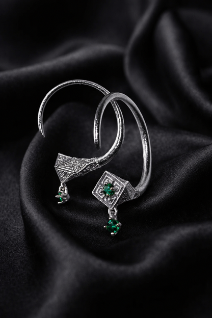 White gold emerald hoop earrings in the Tuareg form, engraved rhombus faces on silk