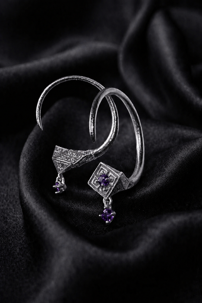White gold Tuareg hoops with amethyst drops, engraved rhombus faces on black silk