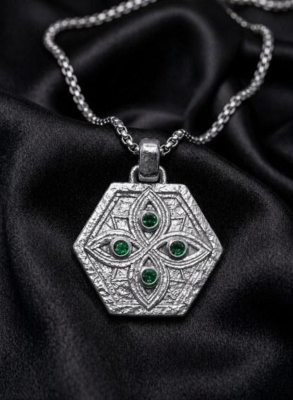 White gold shield with emerald watchers on satin, Ethiopian necklace of the guardian motif