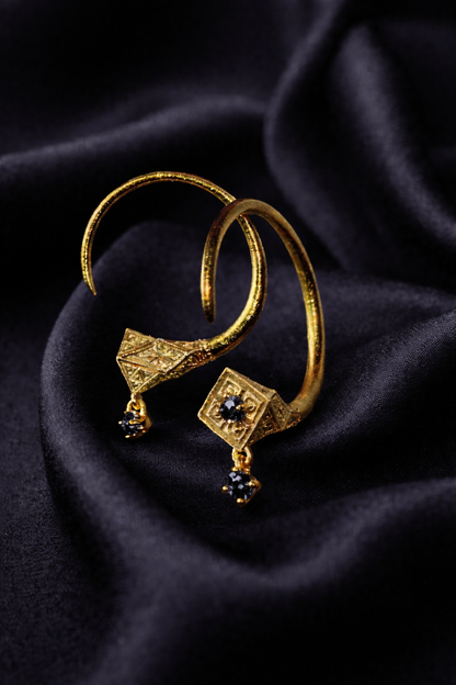 Gold Tuareg Guardian Hoops with black diamonds on dark silk, an evil eye protection amulet pair