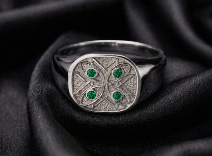 White gold signet with emerald watchers, watcher stones set in scroll geometry