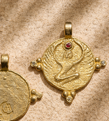 Gold winged Isis pendant with ruby crown stone on sandstone, an heirloom necklace in relief