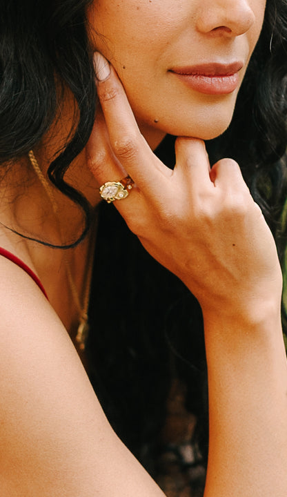 Model wearing the gold marquise ring, hand at chin, heirloom engagement rings styling