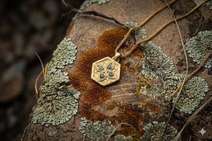 Gold Tibeb shield on lichen covered stone outdoors, a protection talisman in daylight
