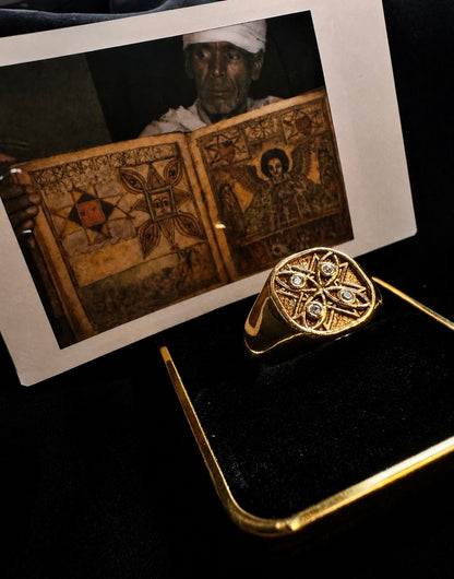 Gold Tibeb signet beside the Ethiopian healing scroll photograph, a custom signet ring in the vigilance tradition