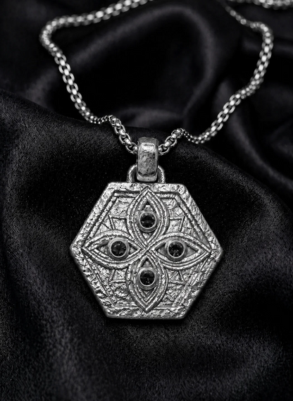 White gold Tibeb shield with black diamond watchers on silk, a protection amulet worn close