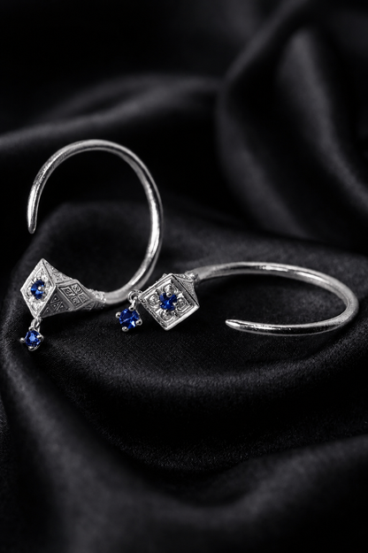 White gold Tuareg hoops with blue sapphires on silk, evil eye protection jewelry in miniature