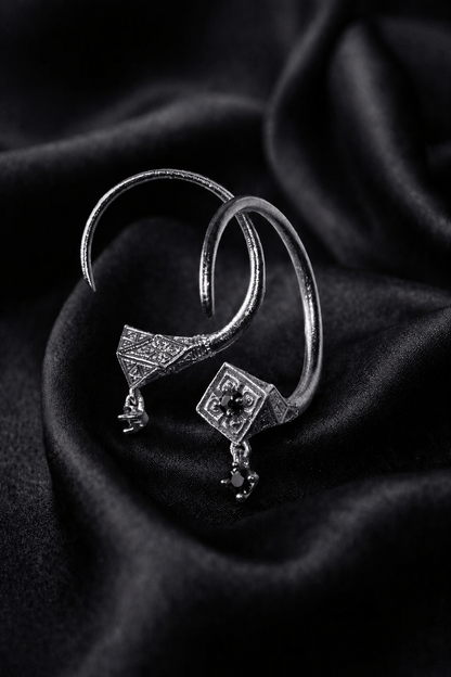 White gold Tuareg hoops with black diamond drops, moroccan jewelry in a pointed silhouette