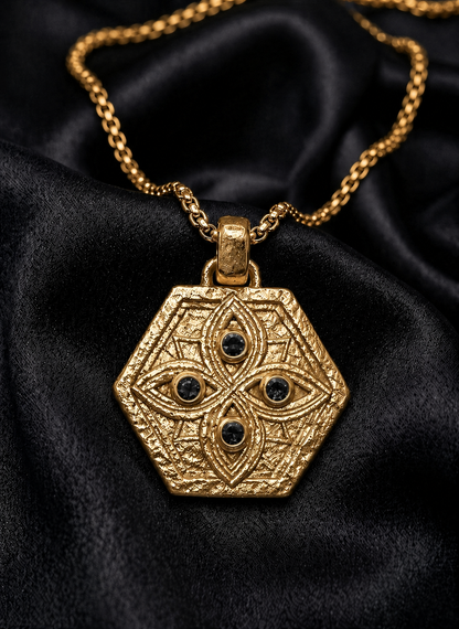 Gold Tibeb shield with black diamond watchers, a protection pendant on woven chain