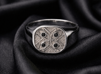 White gold signet with black diamond watchers, engraved guardian geometry in 18k
