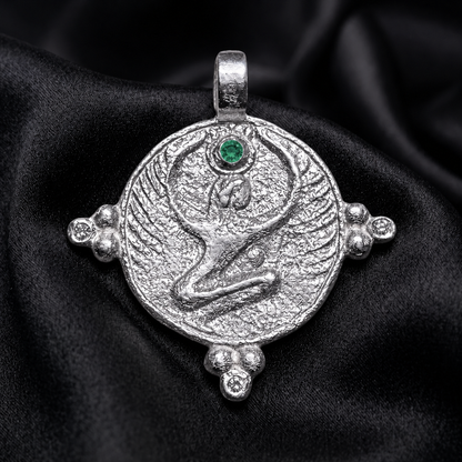 White gold Isis pendant with emerald crown stone, a protection necklace in the winged posture