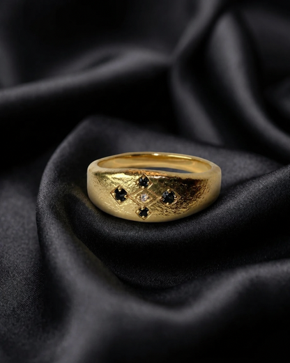 Gold Meskel with black diamond prongs, African gold jewelry on dark silk
