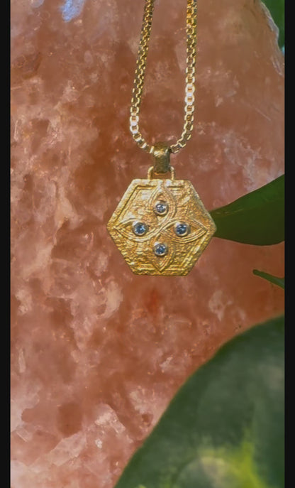 Video of the gold shield pendant with sapphires on rose stone, symbols of protection worn