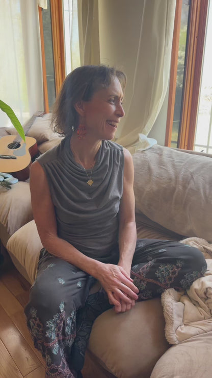 Video of the winged goddess pendant worn at home in natural light, bohemian jewelry ease