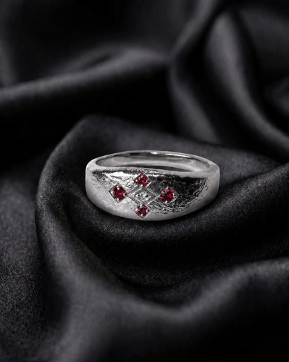 White gold Meskel with ruby prongs, an heirloom ring cut with endless line geometry