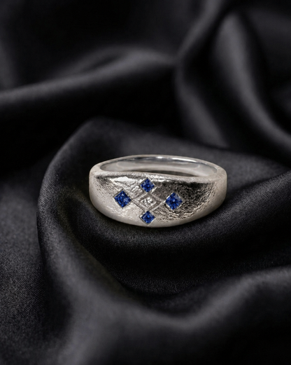 White gold Meskel ring, blue sapphires around a lab diamond, orthodox Ethiopian cross motif